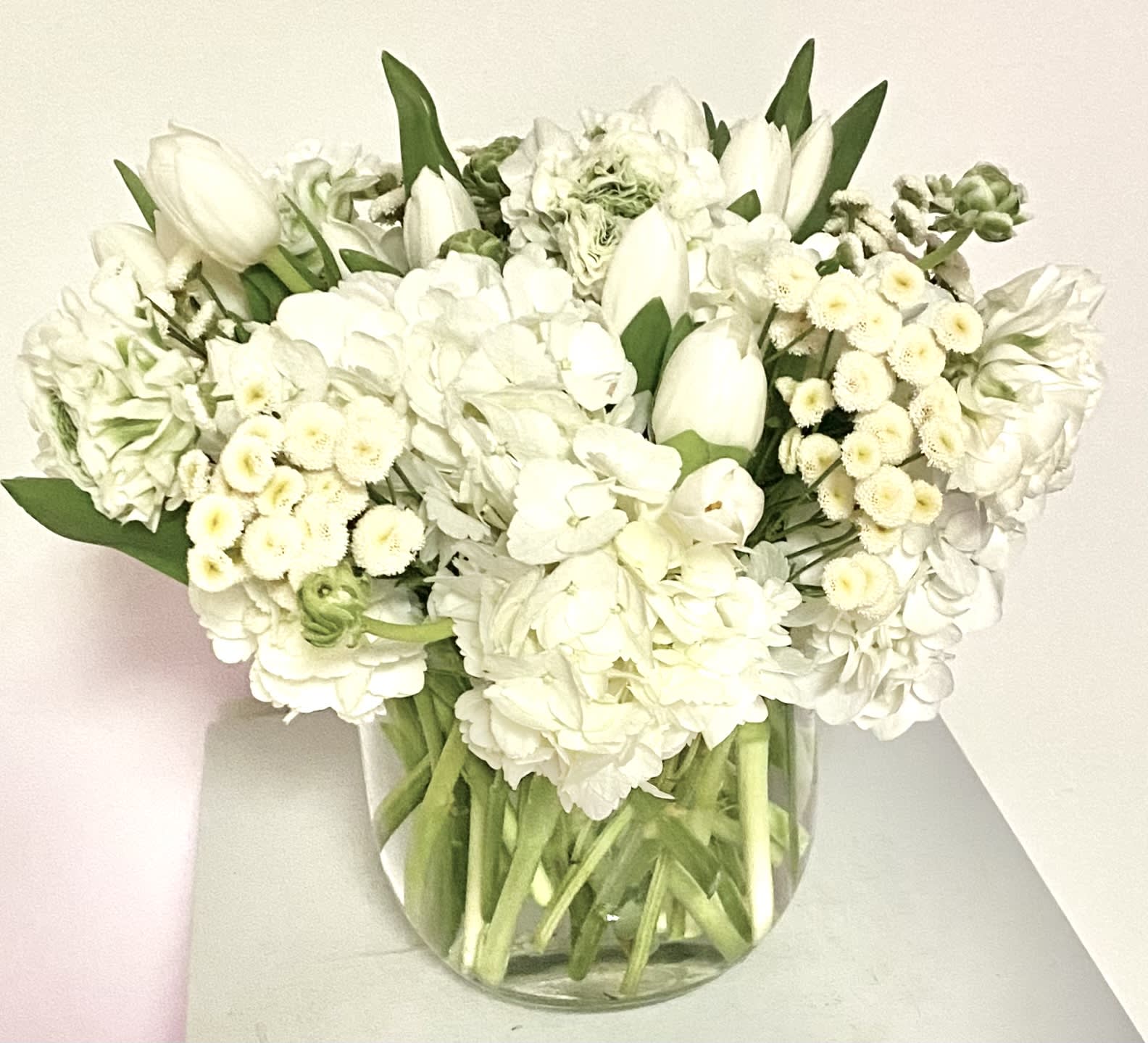 White floral bouquet in a clear glass vase