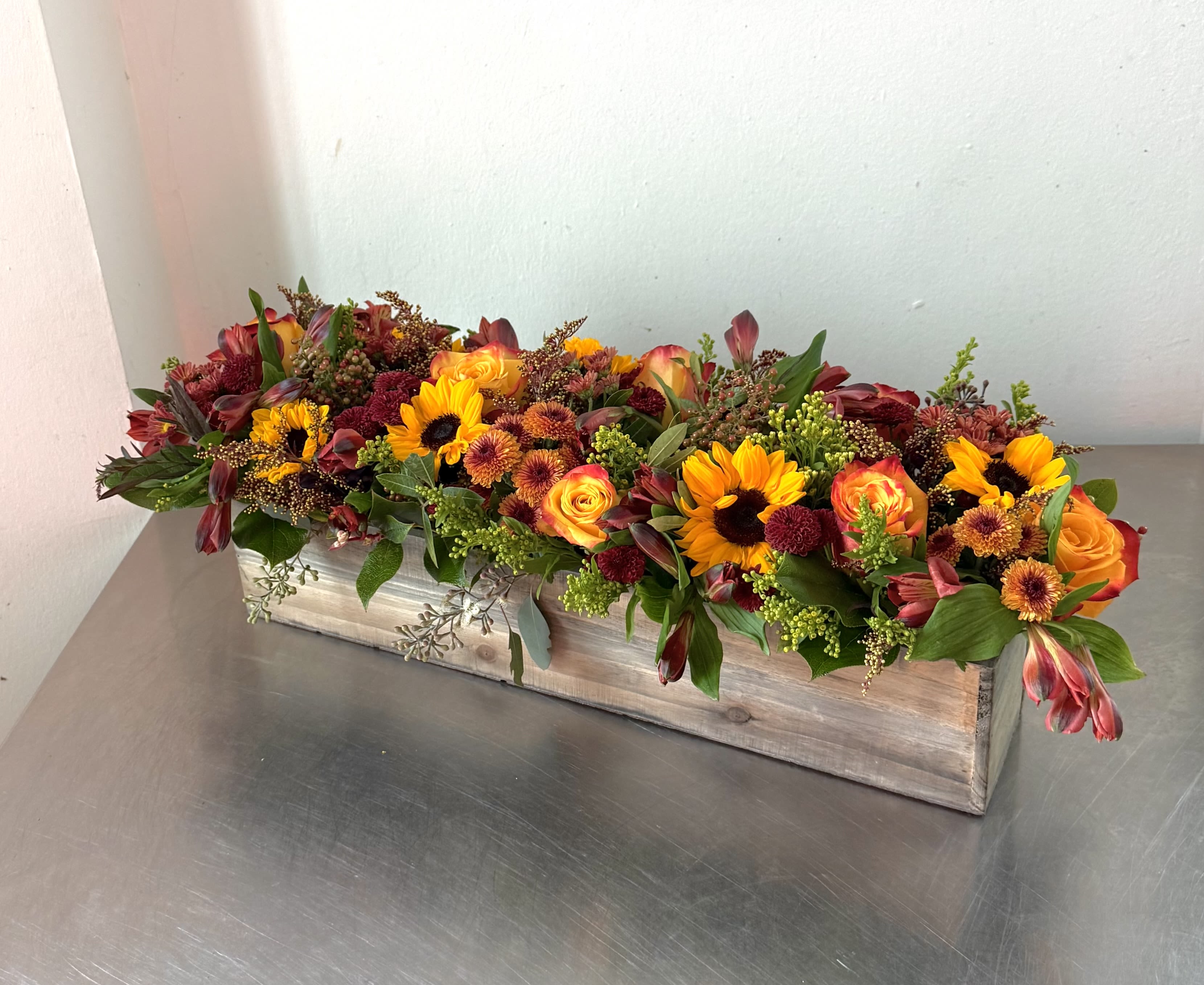 Fall centerpiece  - Autumn Harvest Floral Centerpiece – Sunflowers, Roses &amp; Seasonal Blooms Brighten your table with this stunning handcrafted fall centerpiece from Shoots and Blooms of DC. Designed in a rustic wooden box, this arrangement features vibrant sunflowers, peach garden roses, golden mums, red berries, and seasonal greenery. Perfect for Thanksgiving dinners, fall weddings, and home décor, this design brings warmth and elegance to any setting. Our fresh flower delivery in Washington, DC ensures long-lasting beauty and freshness.