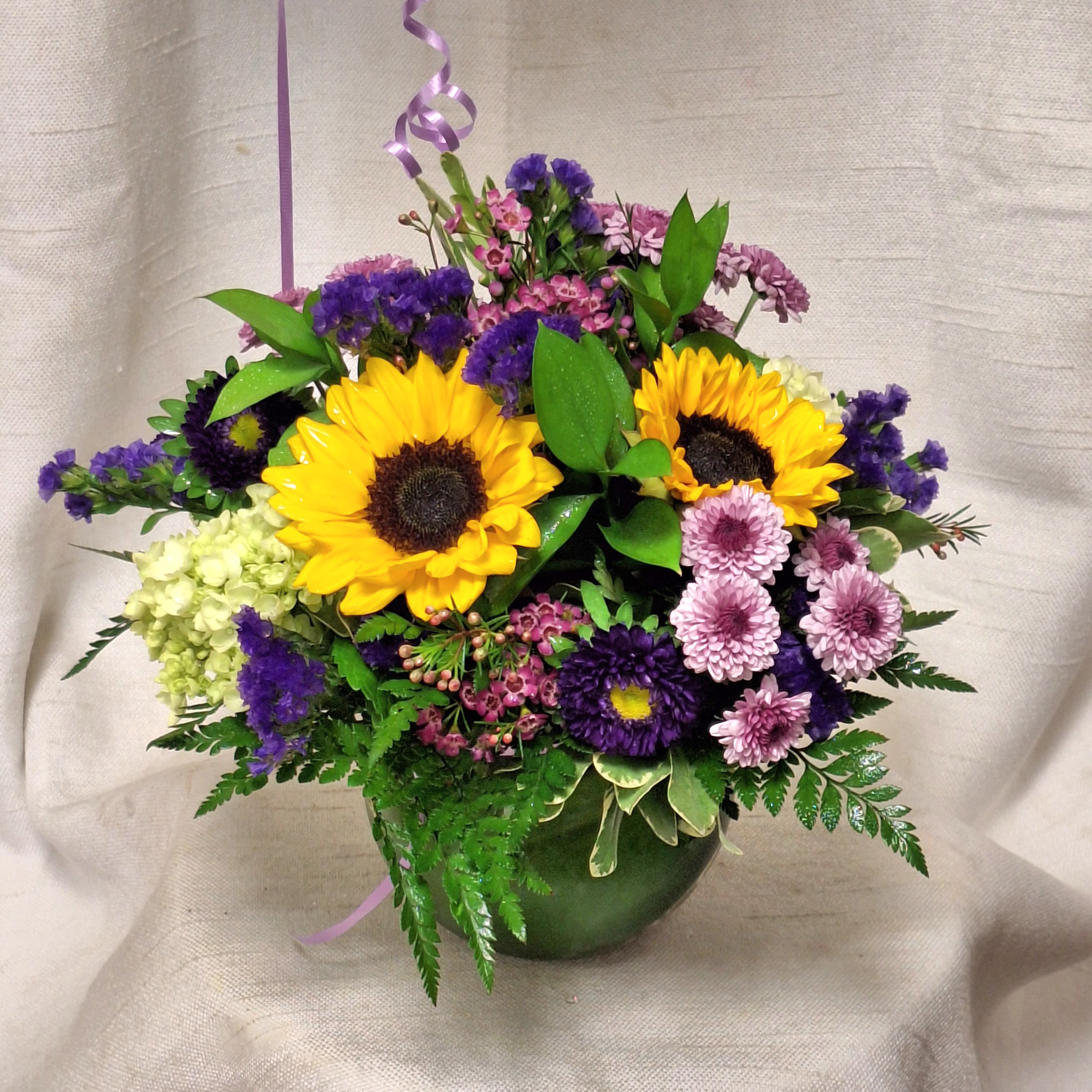 In the Groove (DB) - Celebrate life’s special moments with our "In the Groove" floral arrangement—a harmonious blend of colors pinks and purples. With spray roses, stock and carnations artfully designed to brighten any occasion. Whether you’re congratulating a loved one, honoring Father’s Day, appreciating your best friend, saying thank you, or simply sharing a thoughtful “just because,” this elegant bouquet speaks volumes with its vibrant colors and graceful style.  The soothing mix of hues captures warmth, gratitude, and joy, making it the perfect gift to deepen connections and create unforgettable memories.