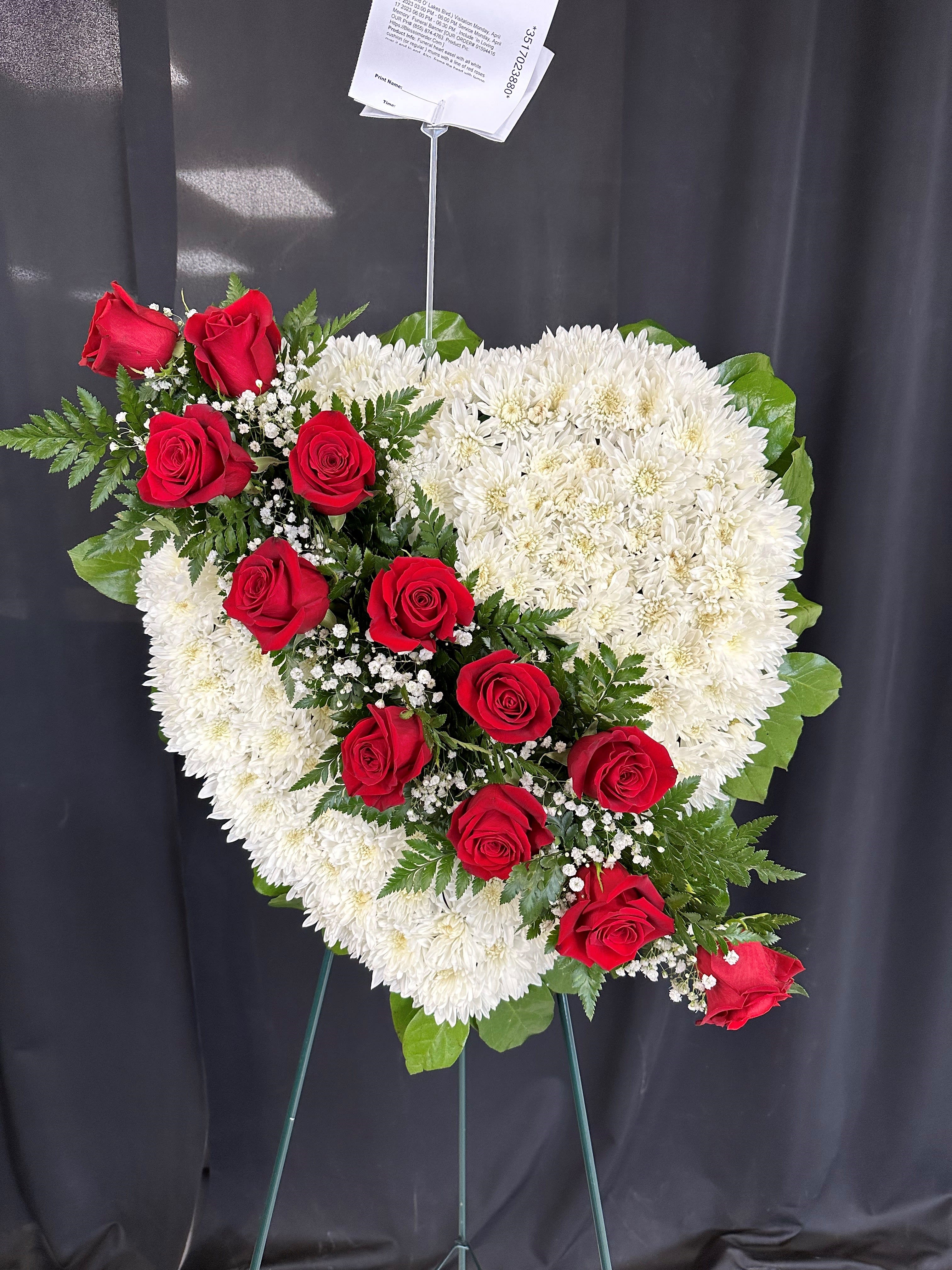 Heart-shaped standing spray of red roses and white chrysanthemums