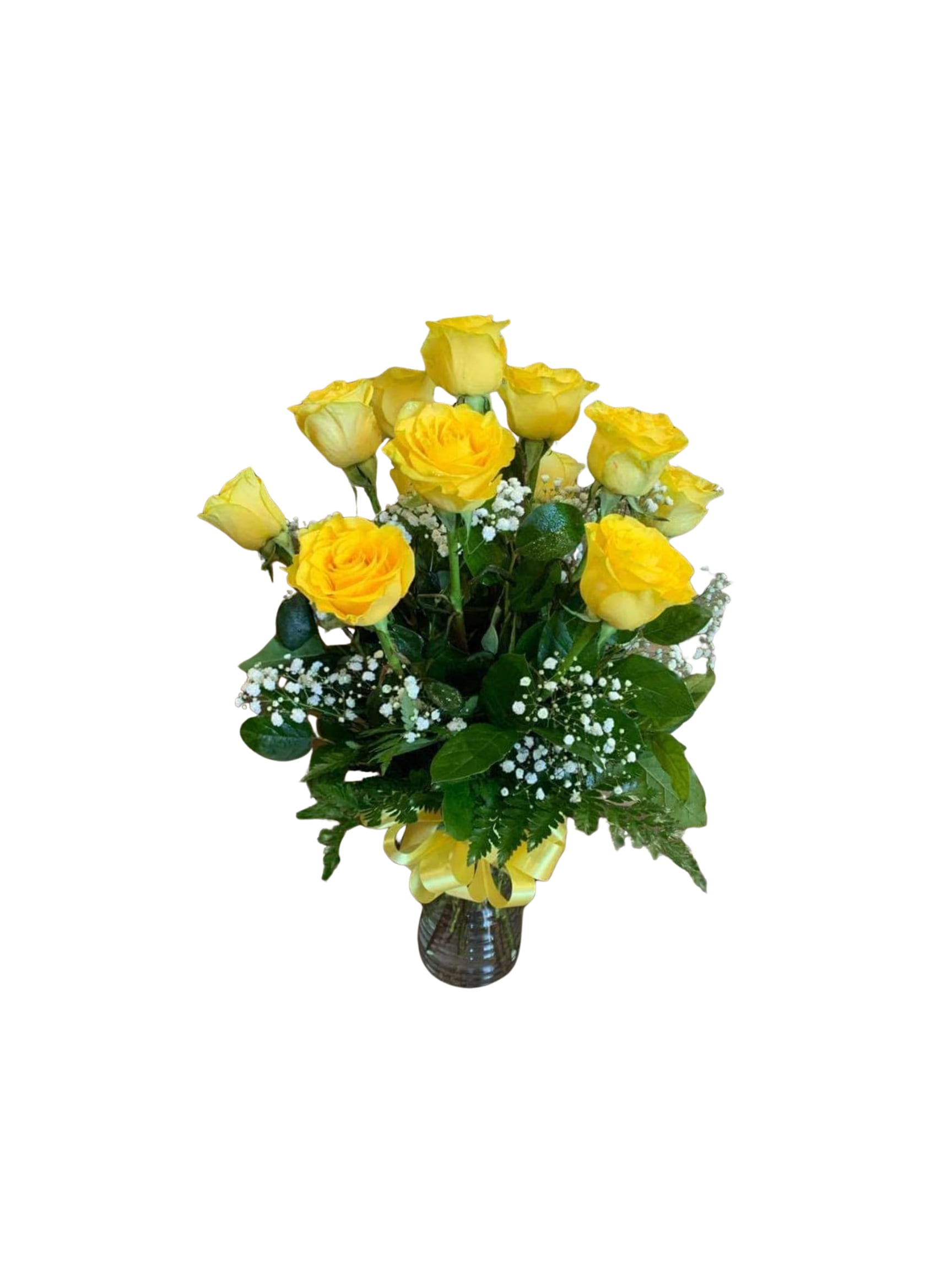 Yellow roses arranged in a glass vase with baby's breath
