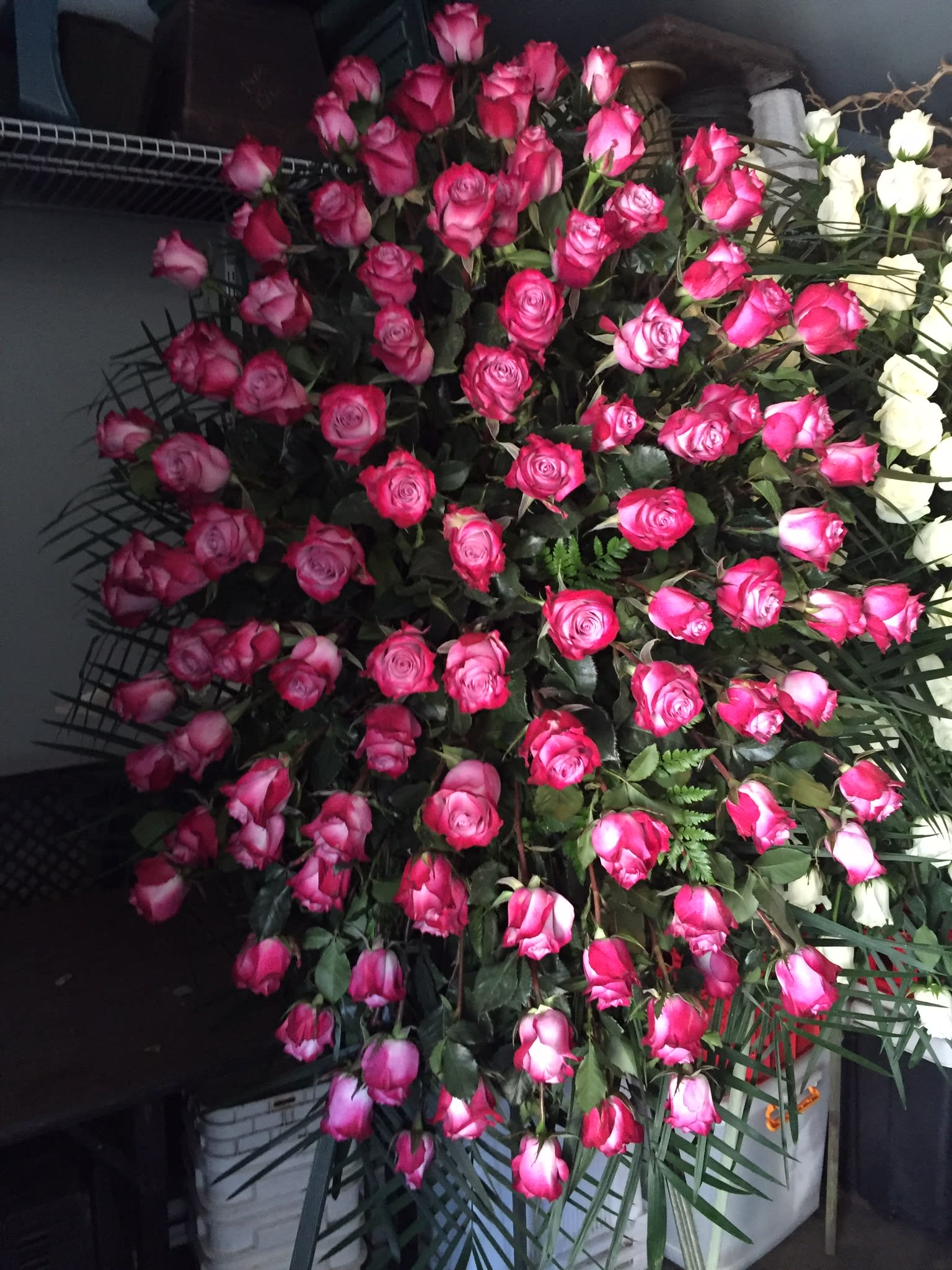 Large bouquet of pink and white roses with greenery