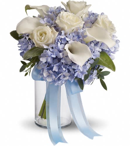 White roses and calla lilies in a glass vase with blue ribbon