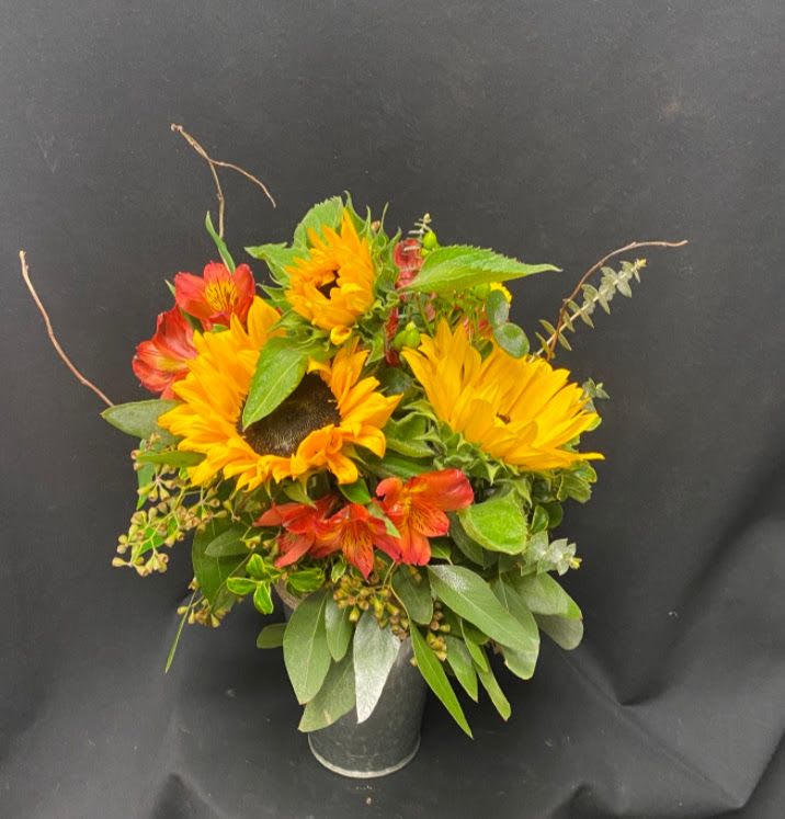 Sunflower and red alstroemeria arrangement in a dark vase