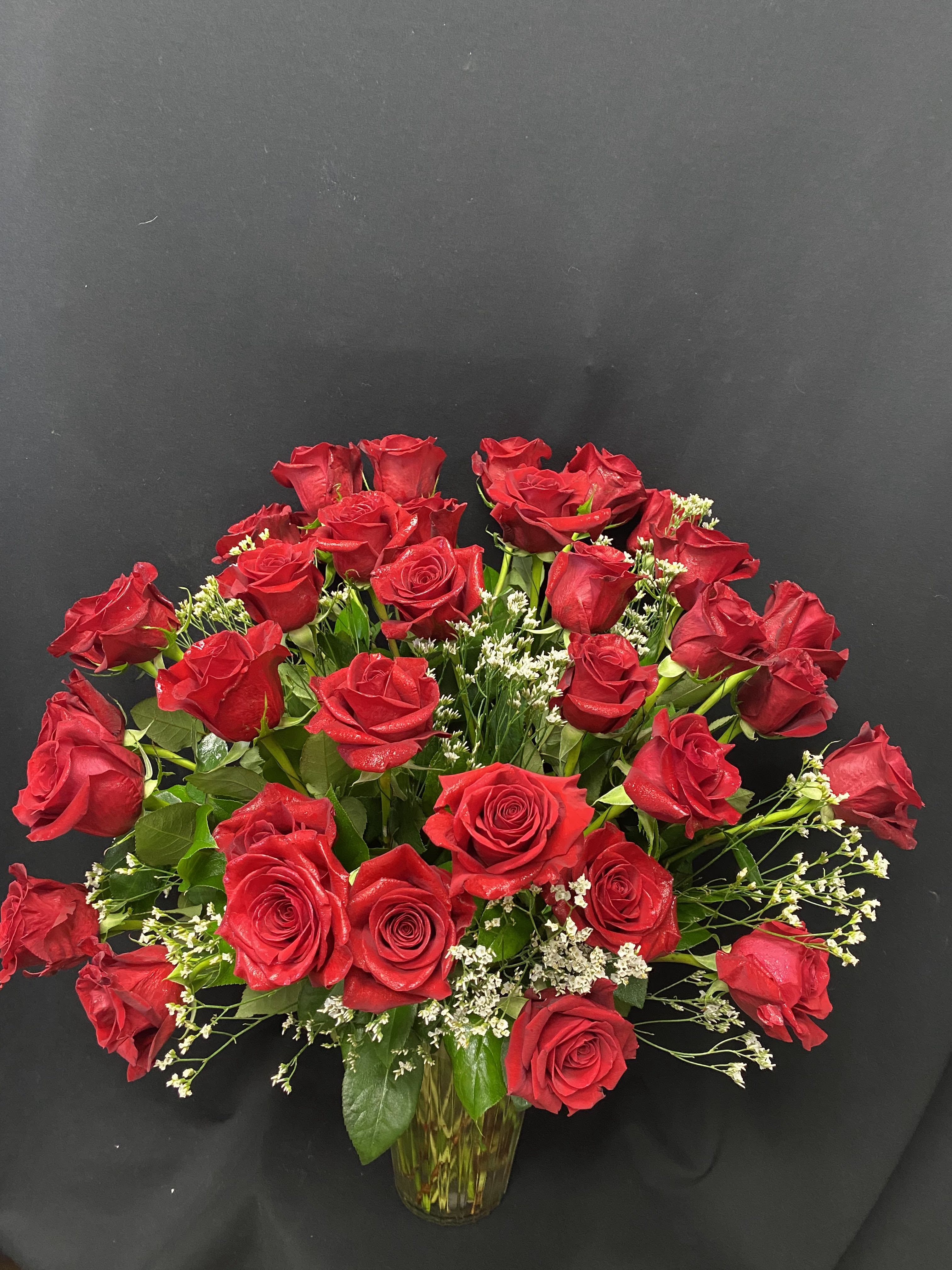 Bouquet of red roses in a clear glass vase