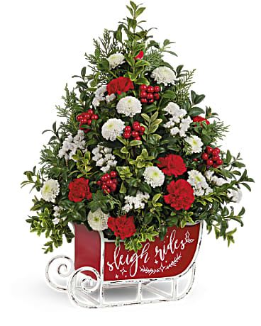 Red and white floral arrangement in a sleigh-shaped container