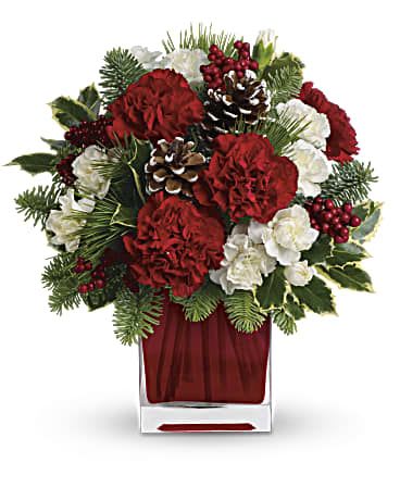 Red and white holiday bouquet in a clear square vase
