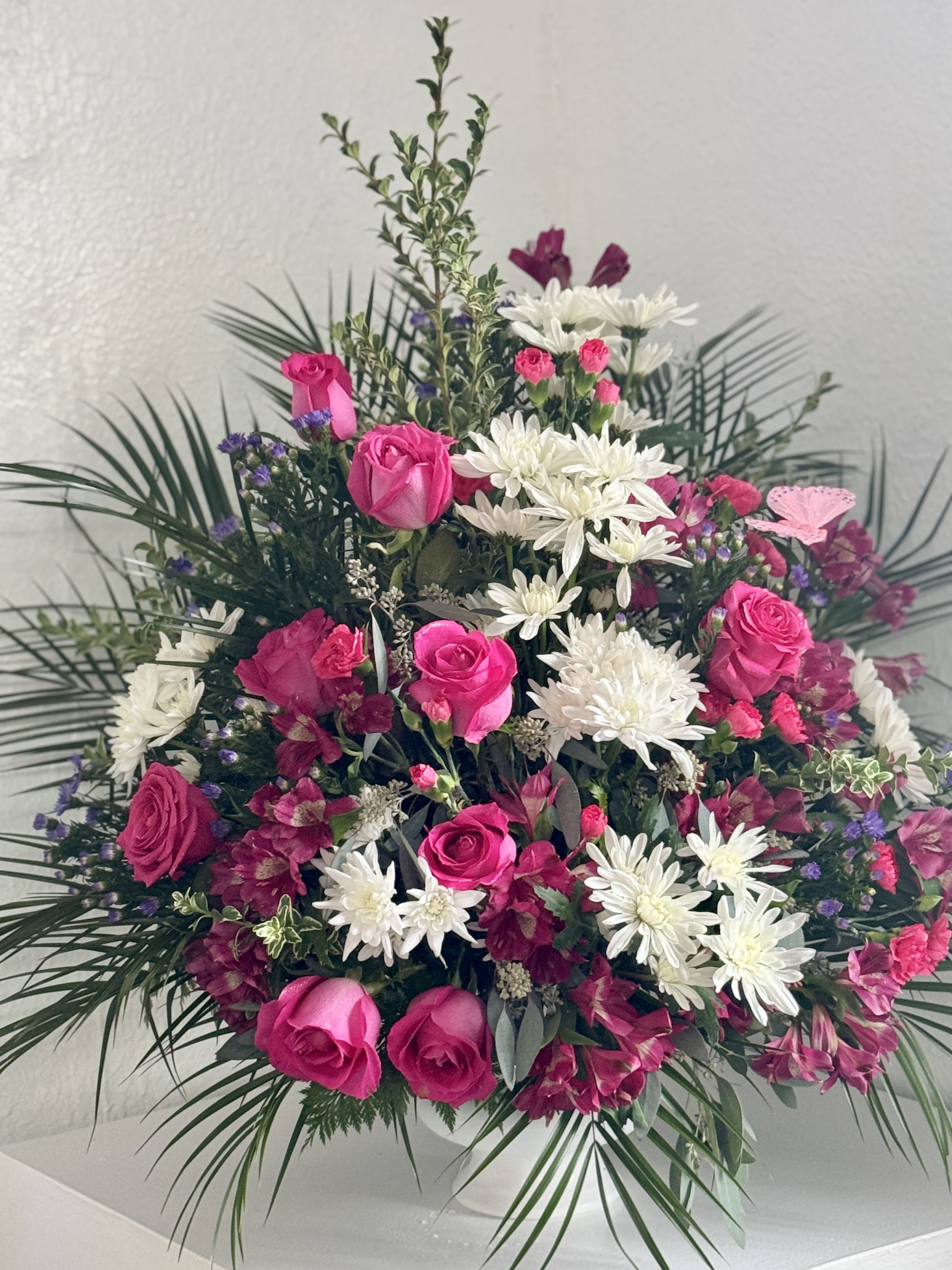 Pink roses and white daisies in a large standing arrangement