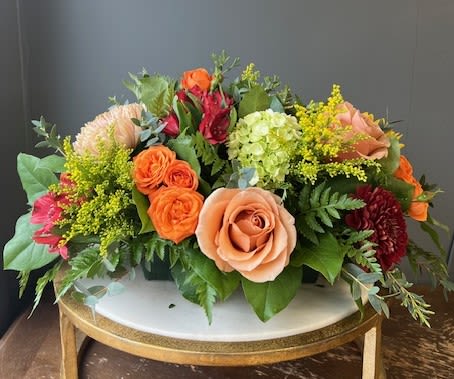 Mixed bouquet of roses, hydrangea, and other blooms on a table