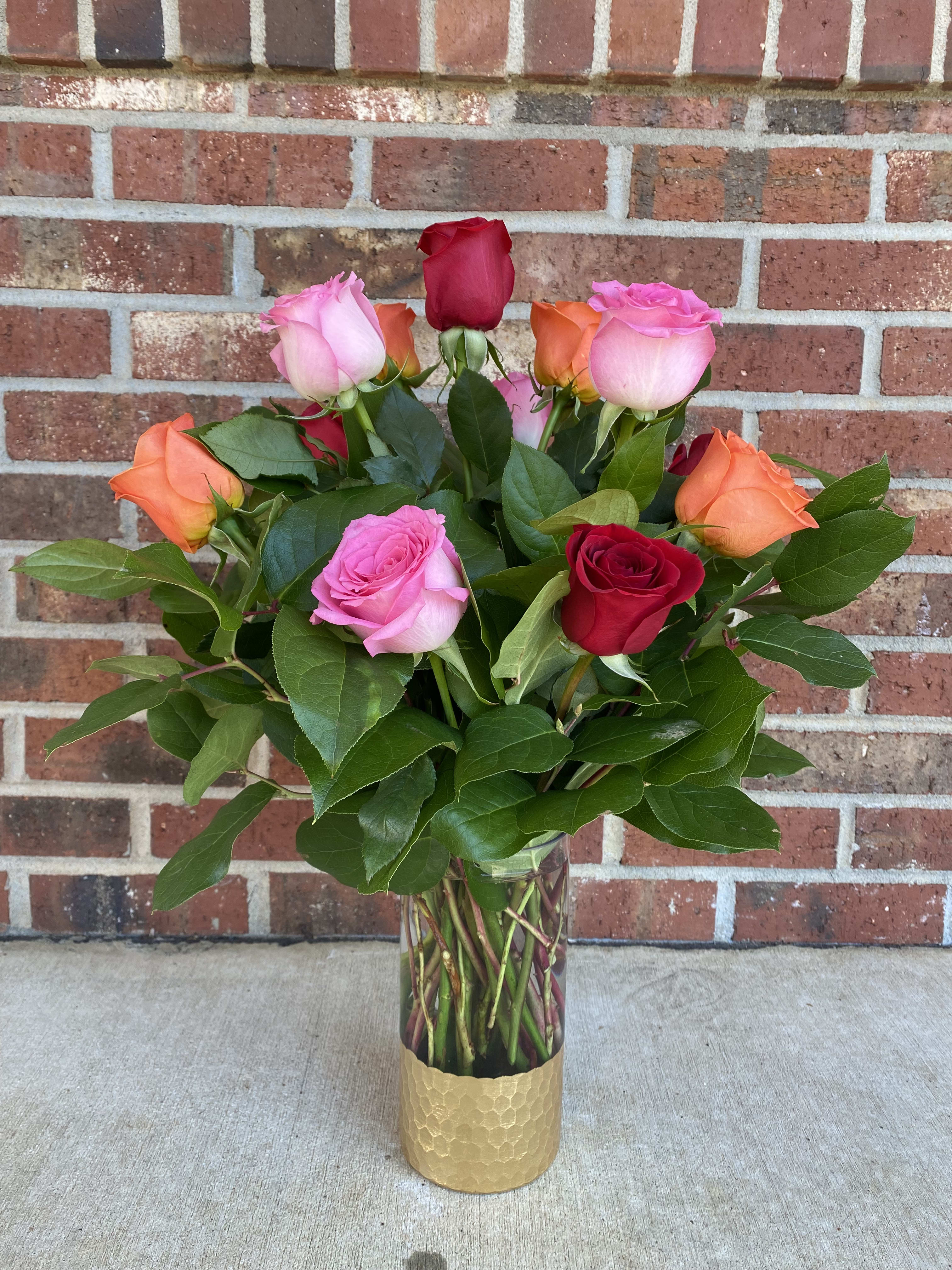 Bouquet of multicolored roses in a clear glass vase