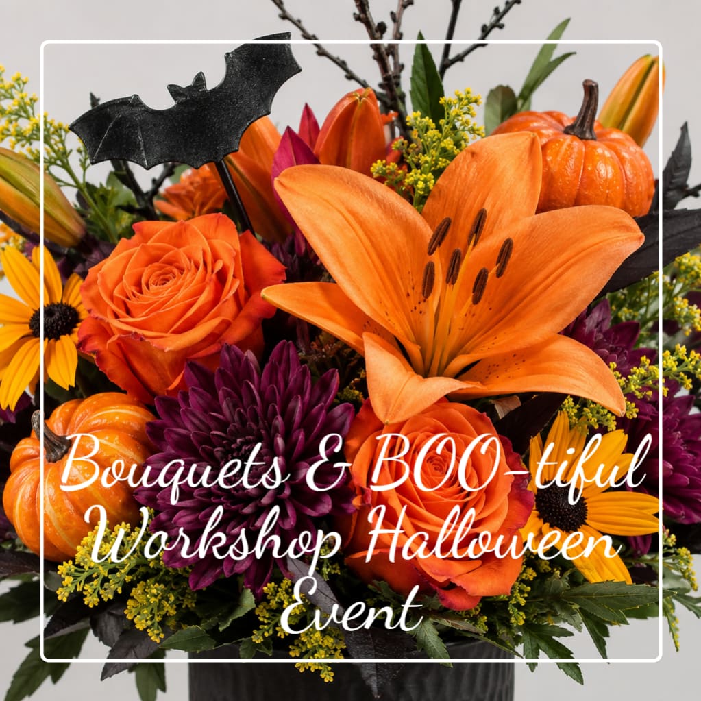 Halloween bouquet with orange lilies, roses, and pumpkins in a black container