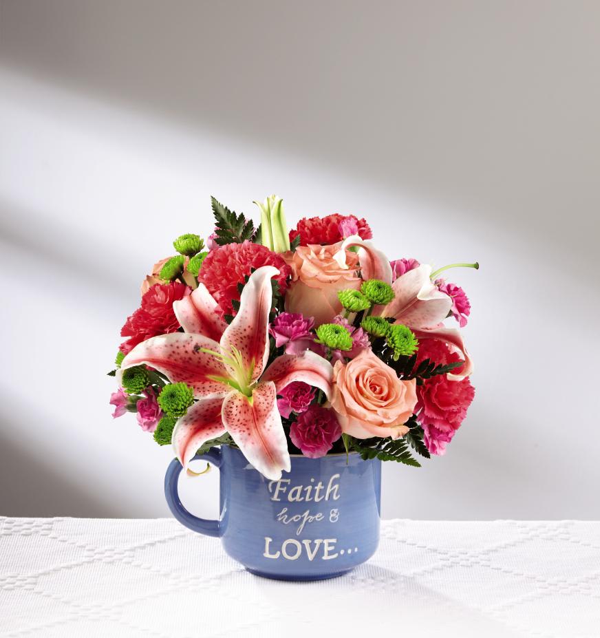 The FTDÂ¨ Be BlessedÂª Bouquet - Deluxe - Bright, beautiful and ready to send your warmest wishes of faith and love to your mom this coming Mother's Day, The FTDÂ¨ Be BlessedÂª Bouquet is the perfect gift! A warm and sunlit arrangement of coral roses, hot pink carnations, hot pink mini carnations, Stargazer Lilies, green button poms and lush greens are presented in a reusable keepsake blue ceramic oversized mug with the sentiment, "Faith, hope &amp; love..." on the front in an attractive white script font. A wonderful way to show your love for your mom this coming May 14th. GOOD bouquet includes 9 stems. Approx. 10"H x 10"W. BETTER bouquet includes 14 stems. Approx. 11"H x 11"W. BEST bouquet includes 17 stems. Approx. 12"H x 12"W. EXQUISITE bouquet includes 22 stems. Approx. 13"H x 13"W.