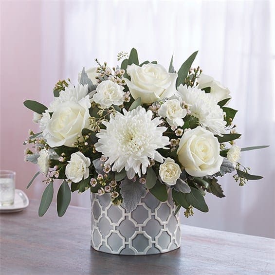 Modern Purity - White roses,white cremone, mini white carnations, dusty miller seeded eucalyptus, white waxflower, variegated pittosporum