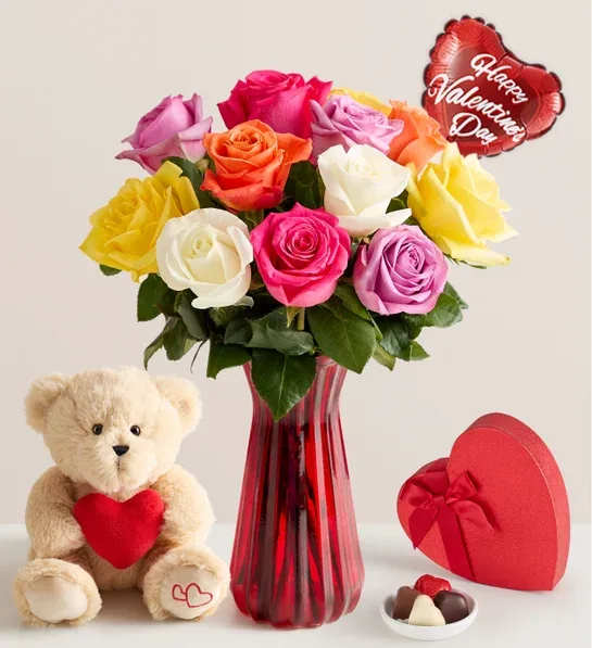 One Dozen Assorted Roses for Romance - Display the full spectrum of your love this Valentine’s Day with a dozen roses in a rainbow of hues. Fresh from our farm to that someone special, the bouquet will show them just how romantic you can be.  Bouquet of 12 multicolored roses; colors may vary based on availability 3 heart-shape milk chocolate  and a medium Teddy bear.