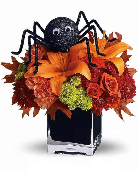 Teleflora's Spooky Sweet - Perhaps this is the perfect WEB bouquet. Perched atop a beautiful array of fall flowers, the only place this sweet spider will crawl is right into someone's heart. Orange spray roses, asiatic lilies and carnations, green button spray chrysanthemums, red spray chrysanthemums, oak leaves and the not-so-itsy-bitsy-spider are arranged and delivered in a modern black cube. Spooktacular!  