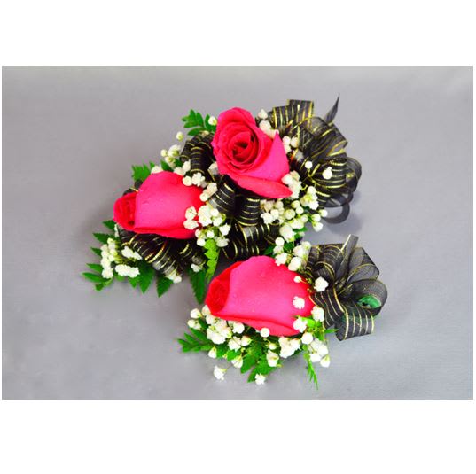 Three pink rose corsages with black ribbon accents