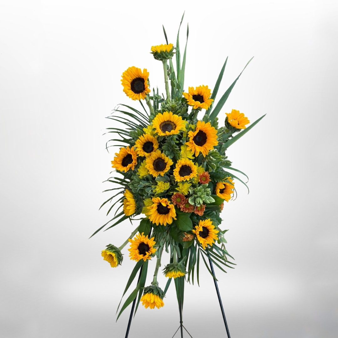 Tall sunflower standing spray on an easel with green foliage