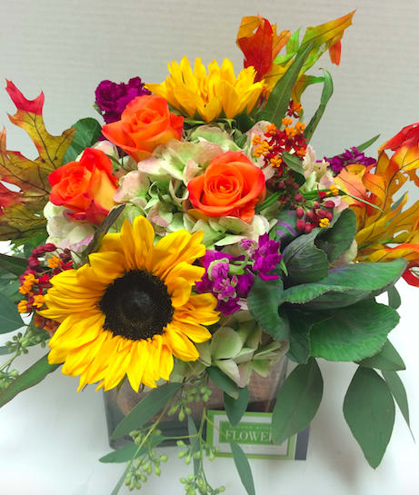 Autumn Creation  - A beautiful fall assortment of fresh blooms including roses, sunflowers, green hydrangea accented with fall leaves and eucalyptus.  A stunning celebration of the season