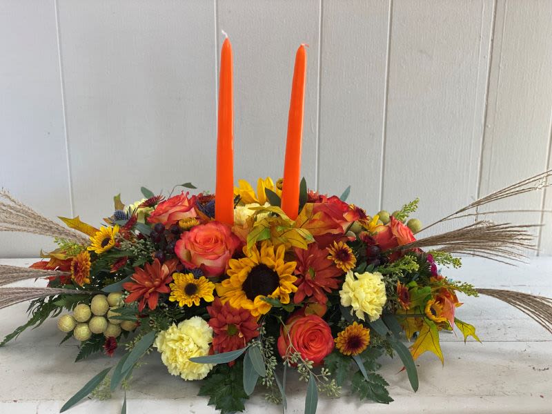 Family Gathering Centerpiece - Mixed seasonal blooms and fall foliage are exquisitely gathered in this center-of-attention piece. 