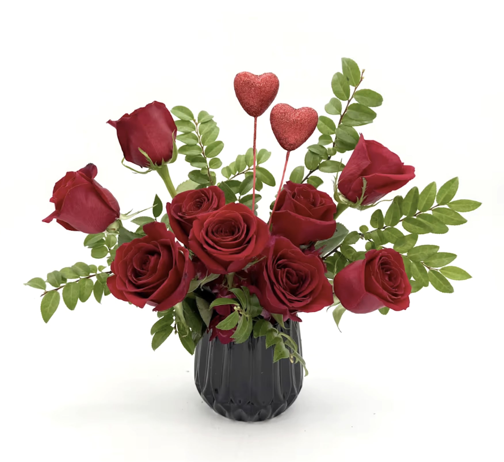 Red roses in a black vase with two glitter heart picks