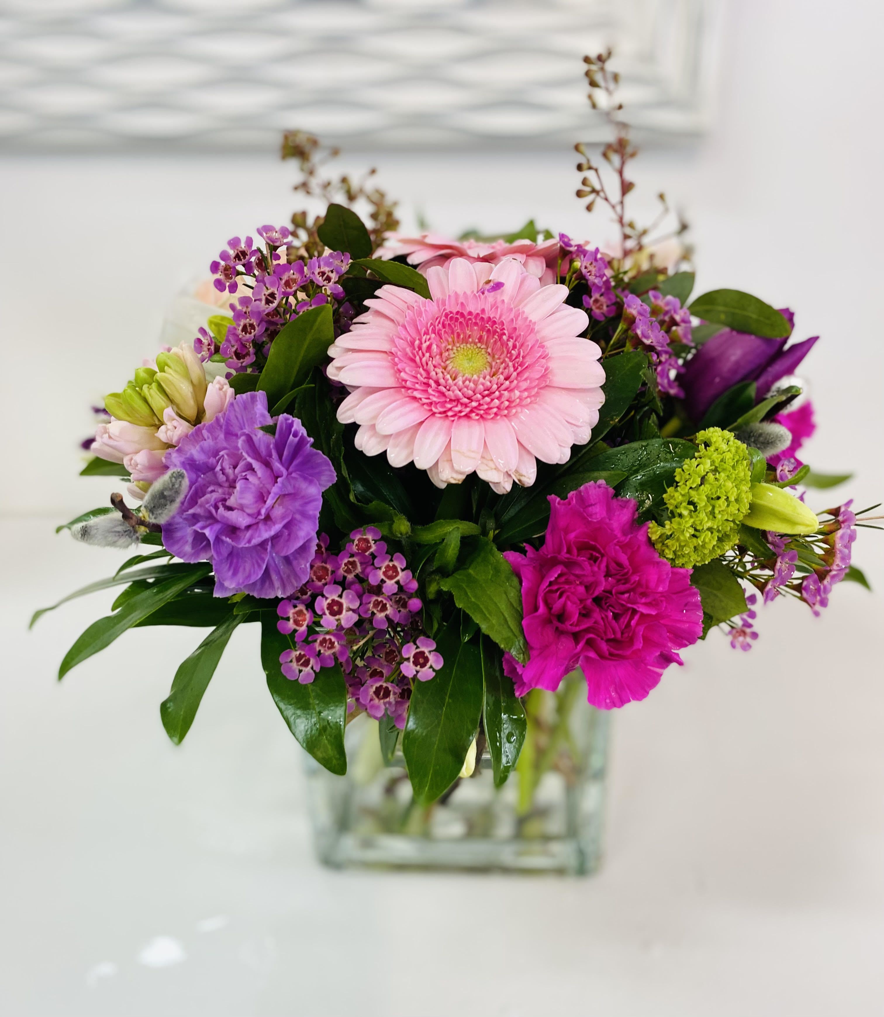 Pink and purple mixed bouquet in a clear glass vase