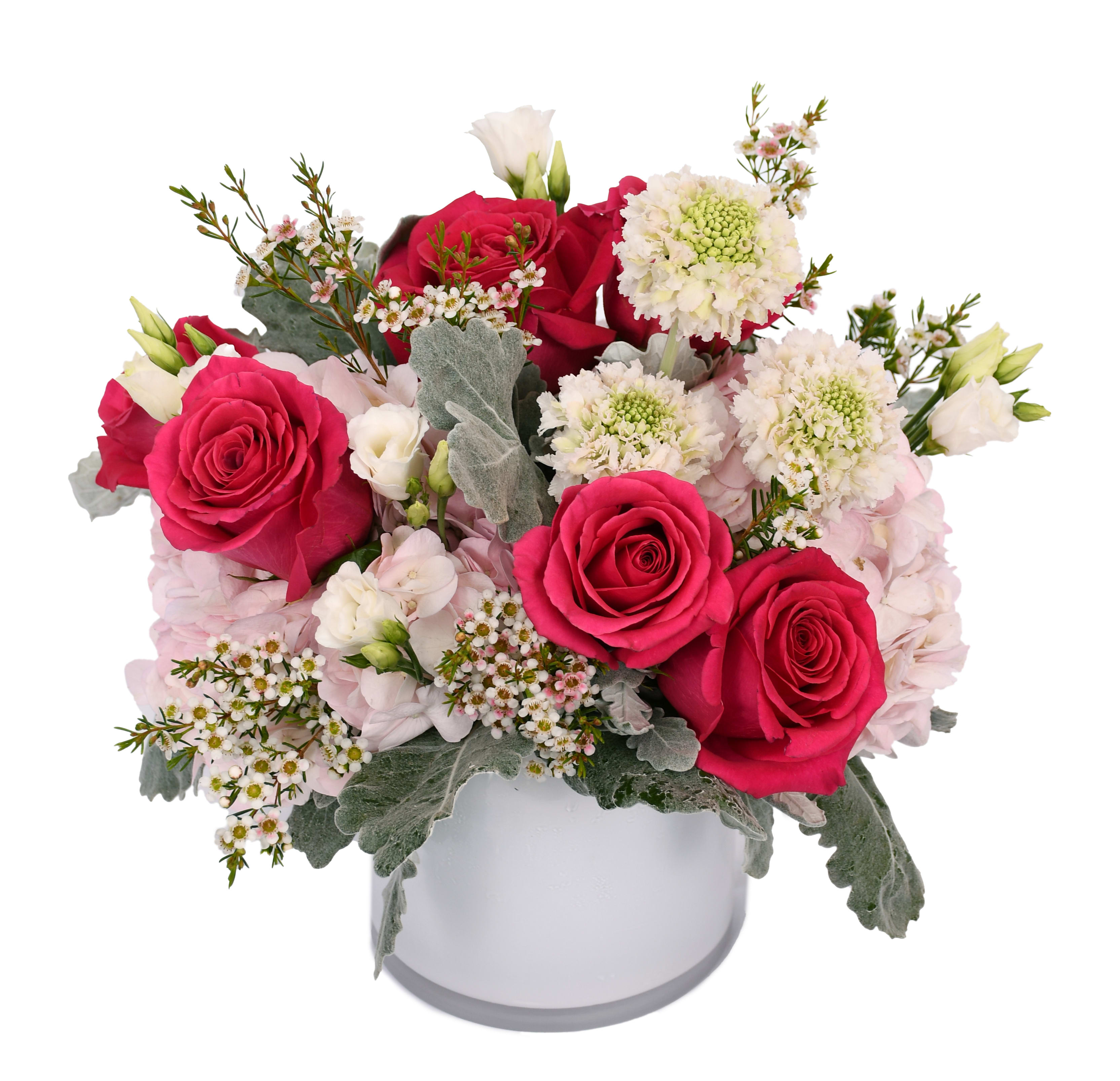 Pink and white rose arrangement in a white hatbox