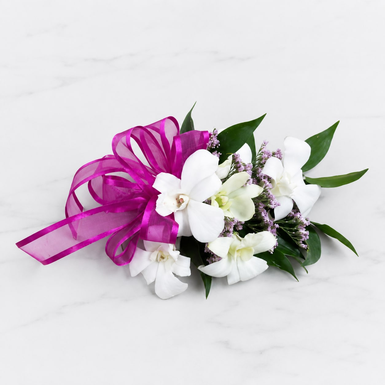 White orchid bouquet with a magenta ribbon bow