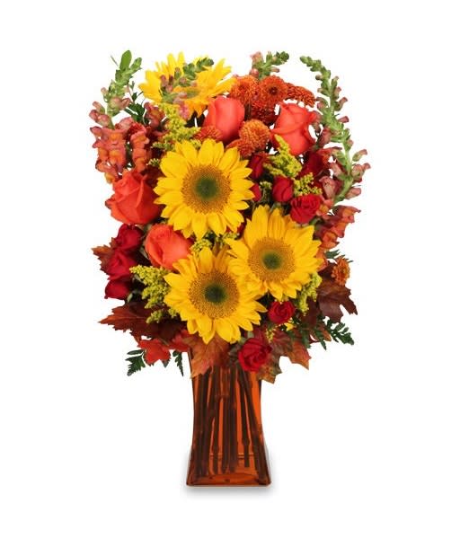 Sunflower and rose arrangement in an amber glass vase