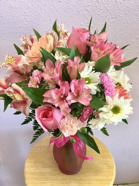 Pink and white mixed bouquet in a vase with a ribbon