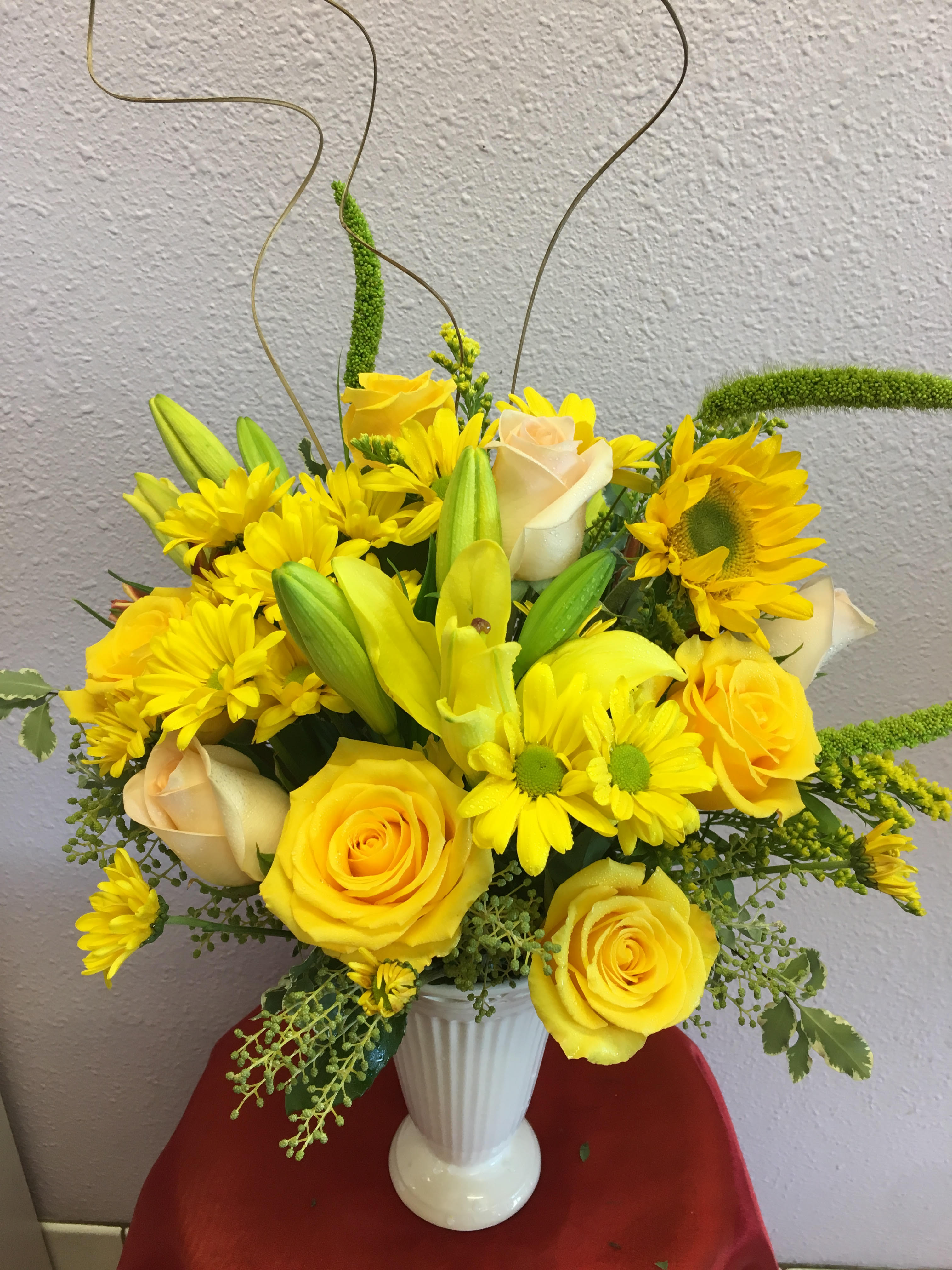 Yellow Skies by Forever Flowers - An arrangement suitable for any occasion. Contains yellow roses, yellow lilies, yellow daisies, sunflowers.