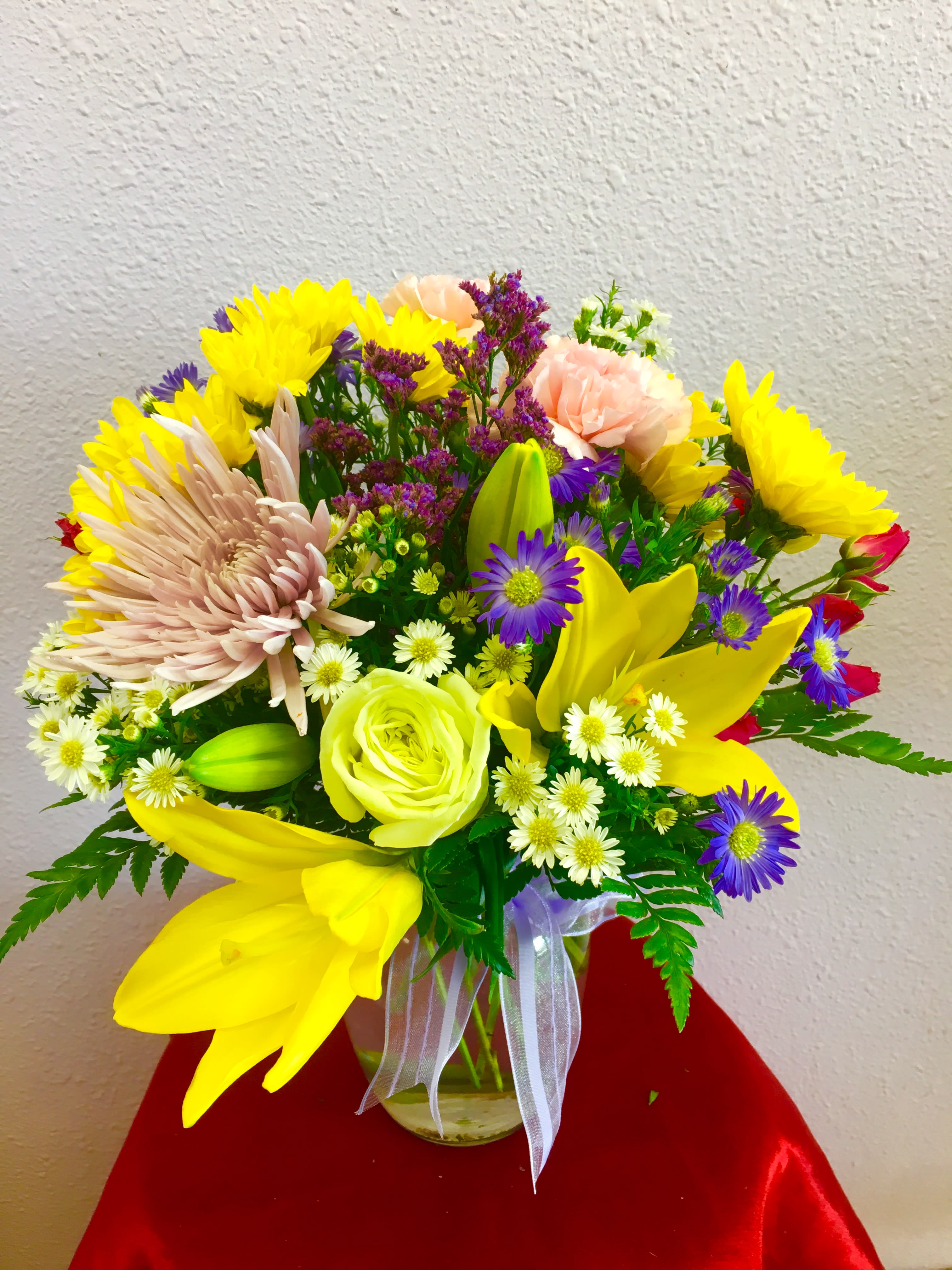 Spring Air by Forever Flowers - A spring bouquet containing lilies, roses, spider mums, daisies, etc..