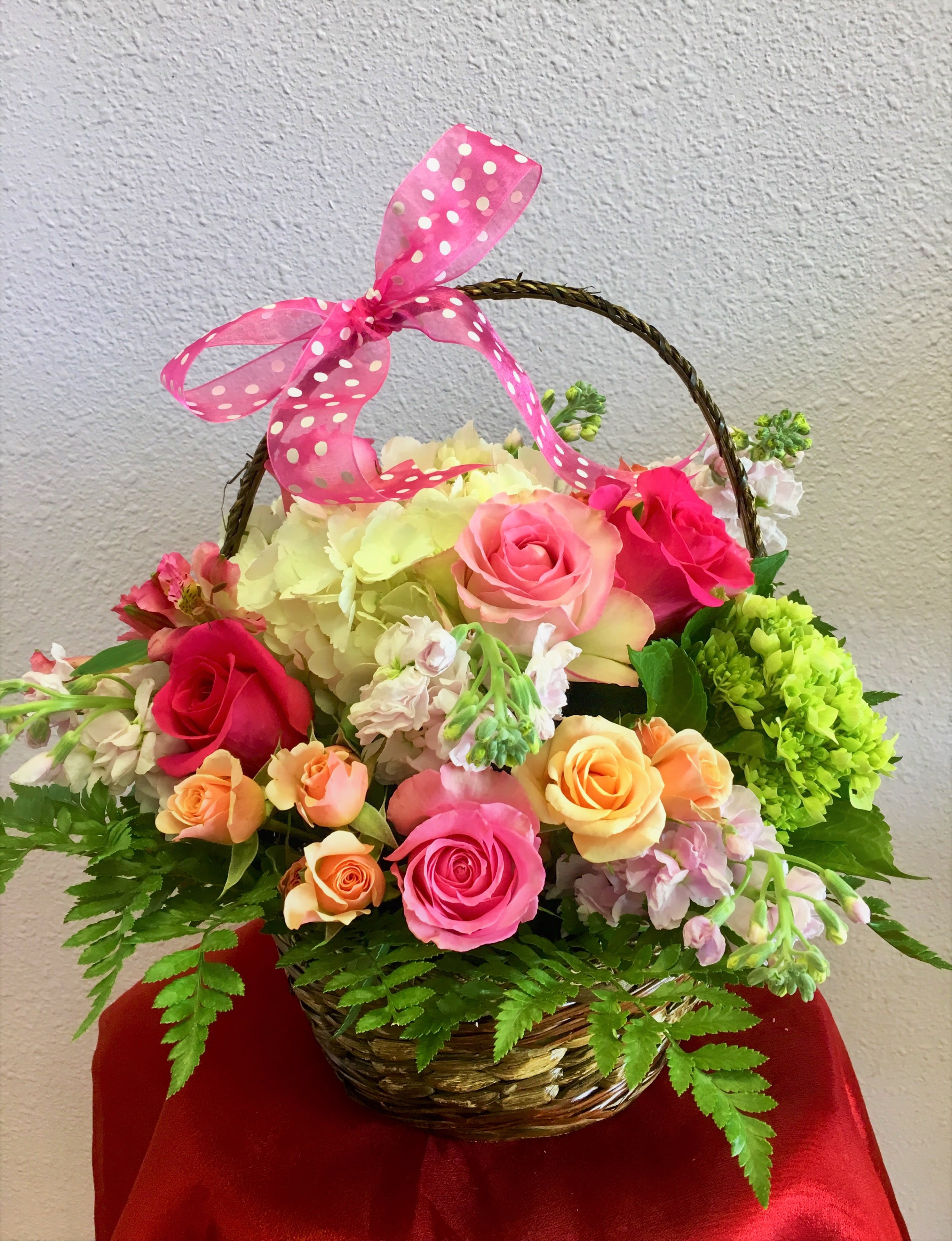 Dipped In Pink by Forever Flowers  - A pink and peach flowered basket arrangement for all occasions.  Contains peach spray roses, peach hydrangea, pink roses, greens and fillers. 