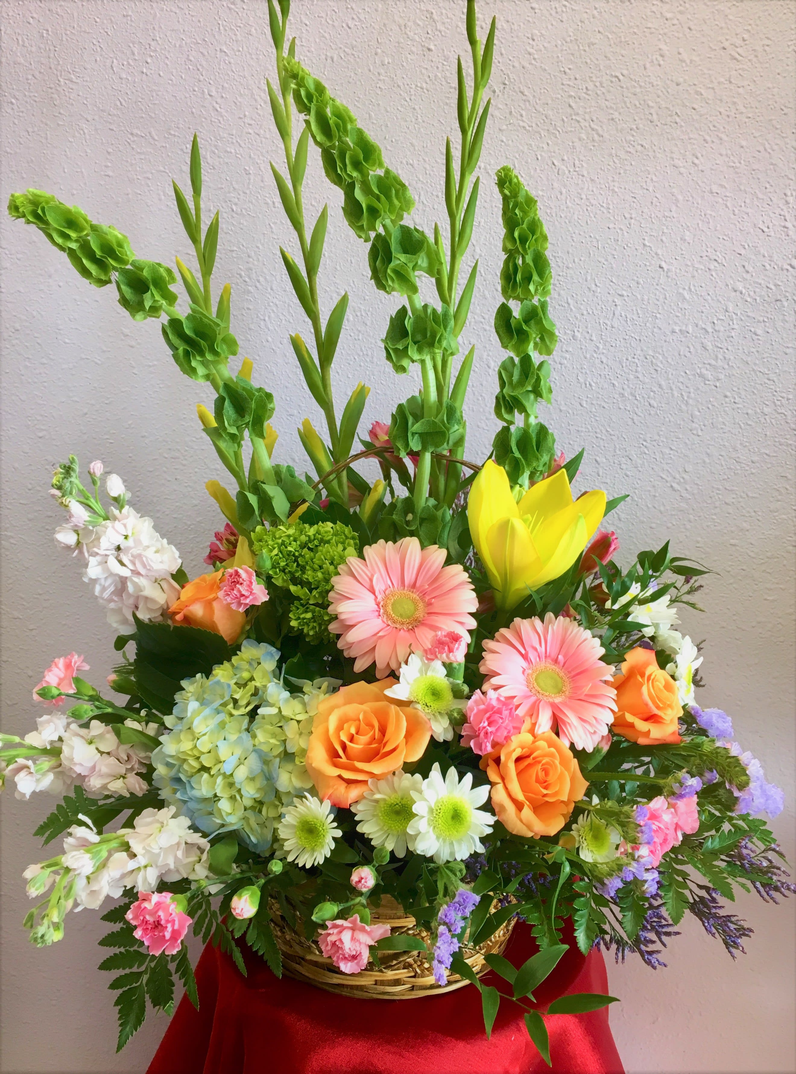Lullaby by Forever Flowers - A large basket with colorful pastels containing roses, gerberas, lilies, gladiolas, and other blooms. 