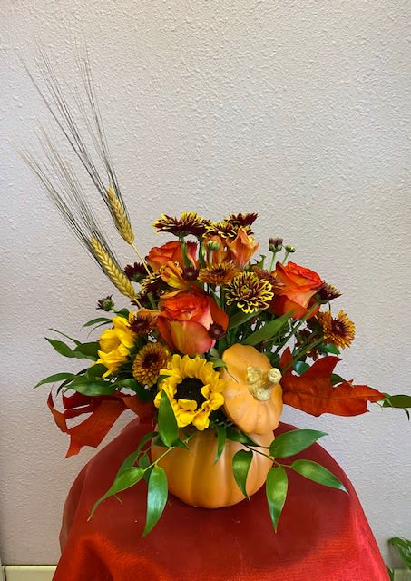 Pumpkin Season by Forever Flowers - Ceramic pumpkin, daisies, sunflowers, roses, and alstroemeria with dry wheat making this cute arrangement perfect for the autumn season!