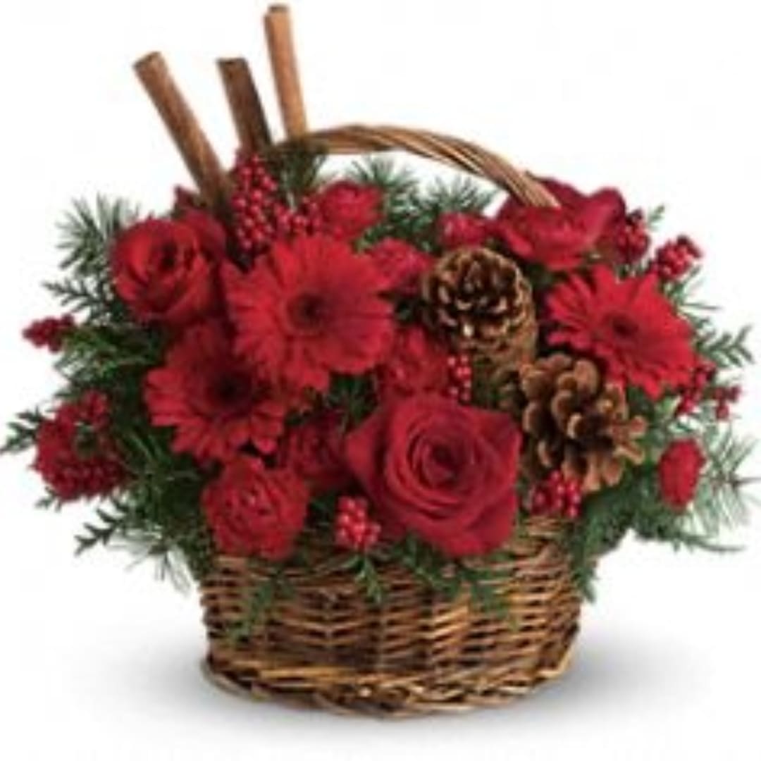 Red flowers arranged in a wicker basket with pinecones