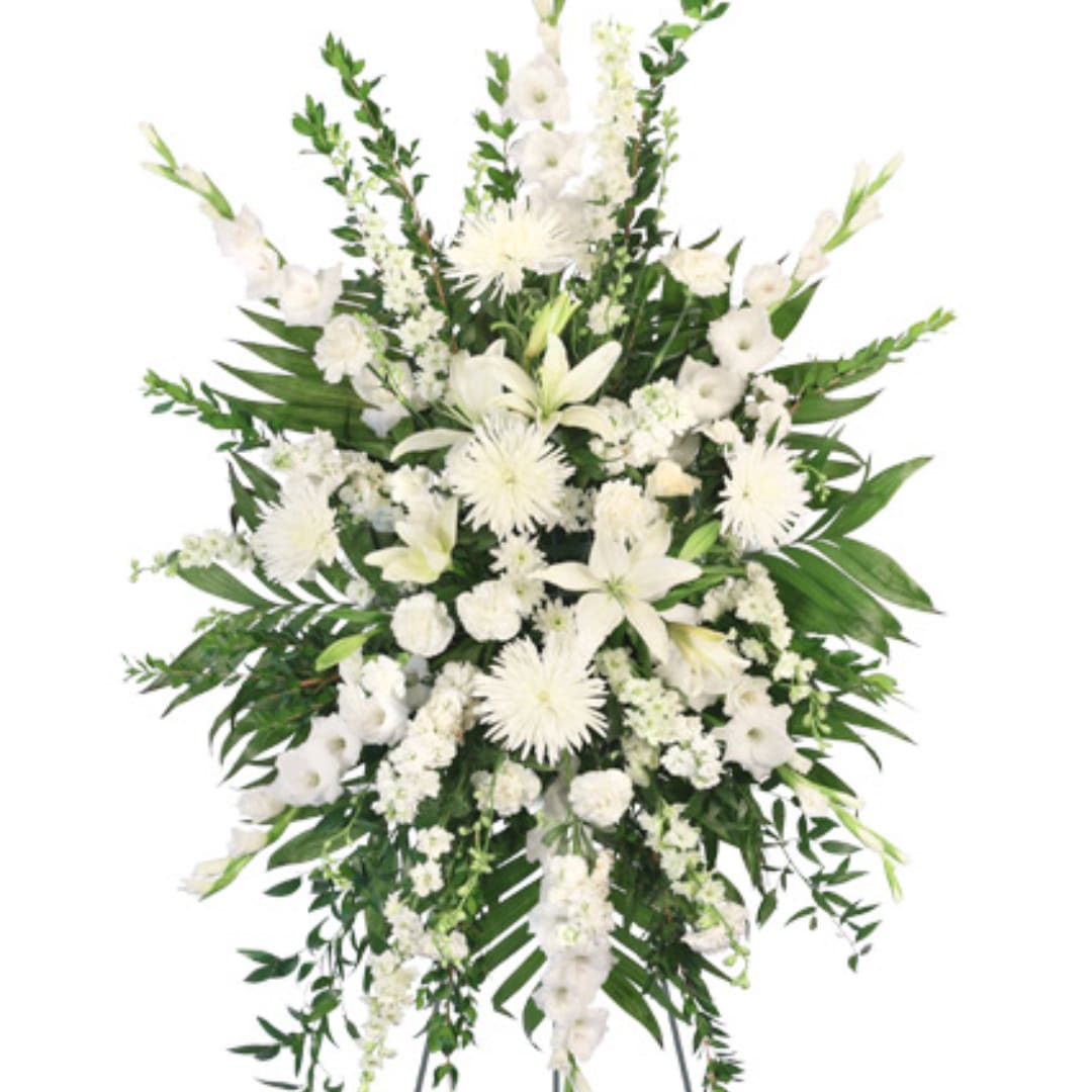 White funeral spray with lilies and chrysanthemums on a white background