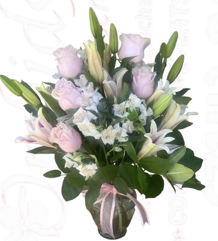 Bouquet of pink roses and white lilies in a glass vase