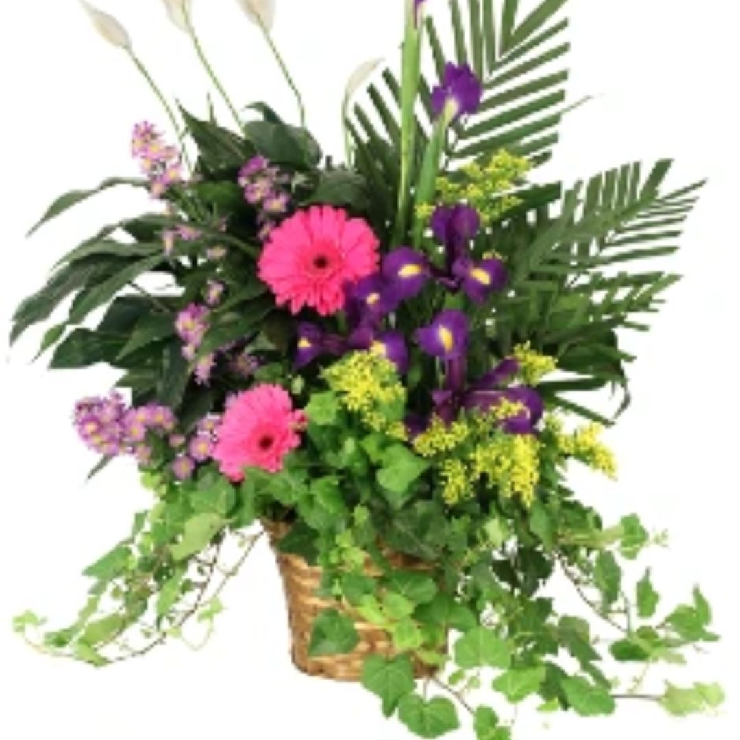 Mixed floral arrangement in a wicker basket with pink and purple blooms
