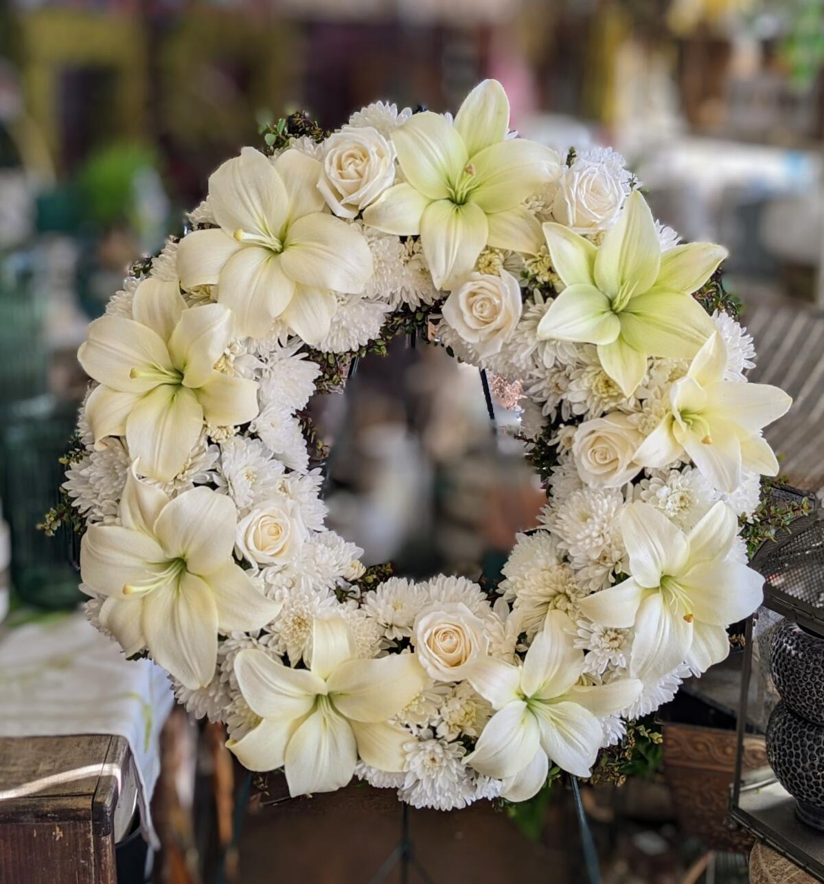 White floral wreath with lilies and roses