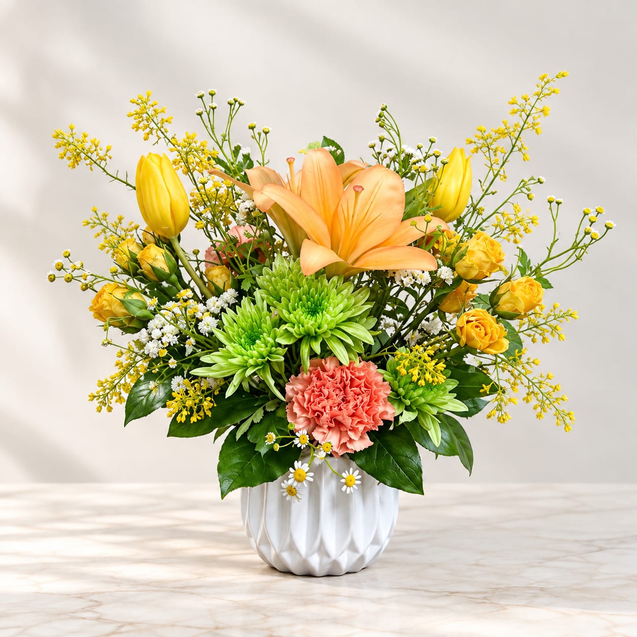 Yellow and peach floral arrangement in a white vase