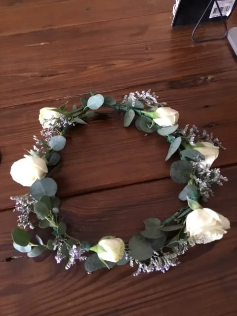 White rose floral crown with eucalyptus and small purple filler flowers