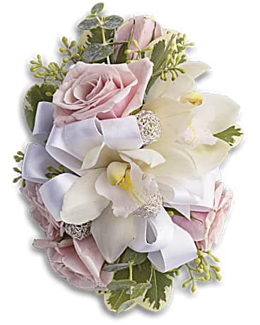 Pink roses and white orchids arranged with a pale ribbon
