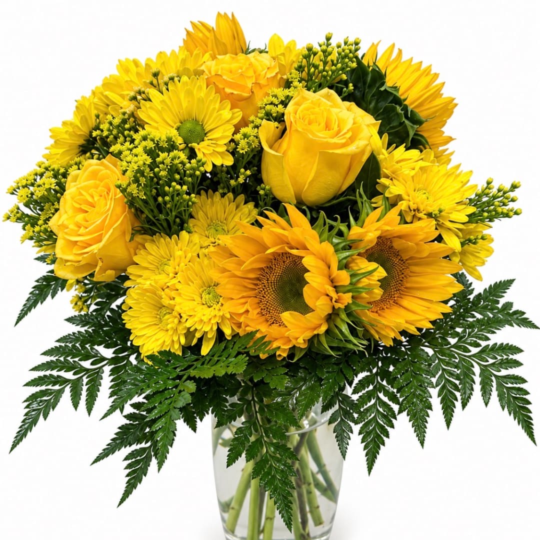 Yellow roses and sunflowers arranged in a clear glass vase