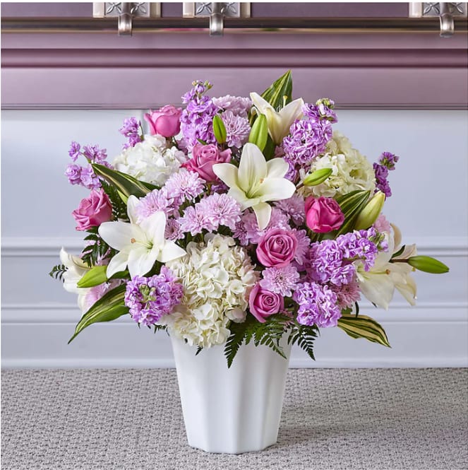 Pink and white floral arrangement in a white vase