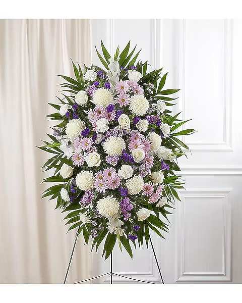 Standing floral spray of white, pink, and purple flowers on an easel