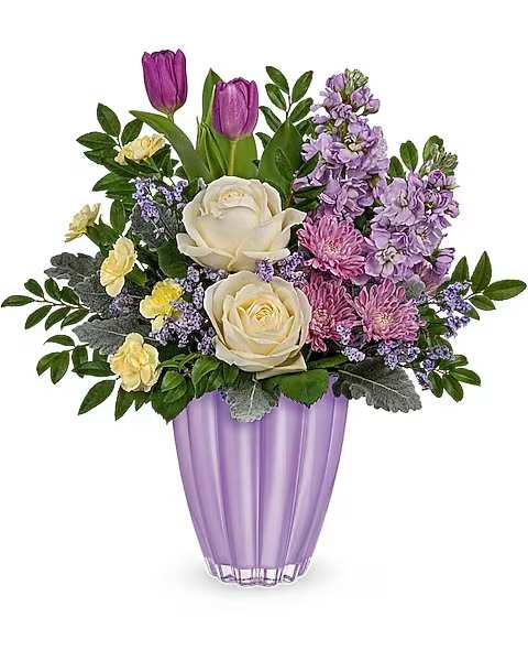 Purple and cream floral arrangement in a lavender vase