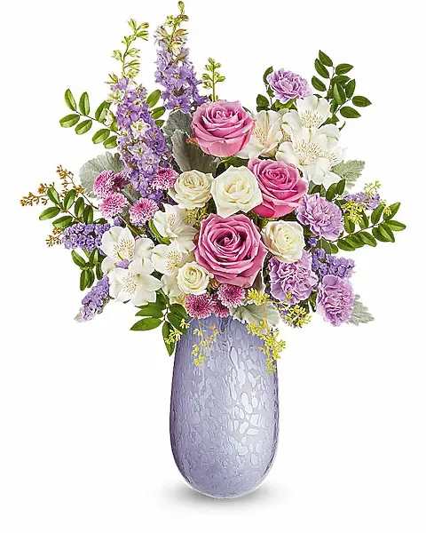 Bouquet of pink and white roses with purple flowers in a lavender vase