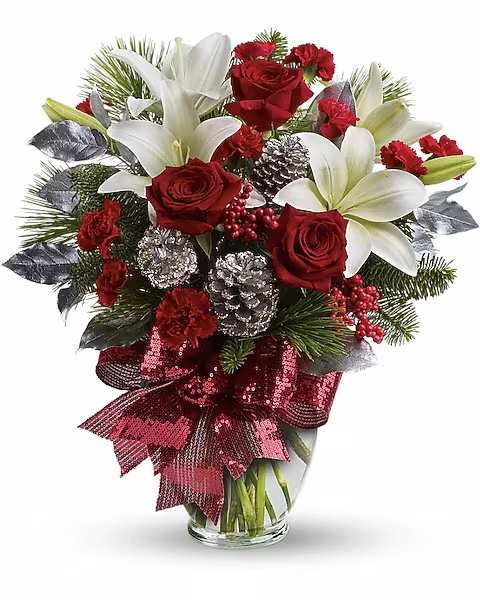 Red roses and white lilies in a glass vase with a red ribbon