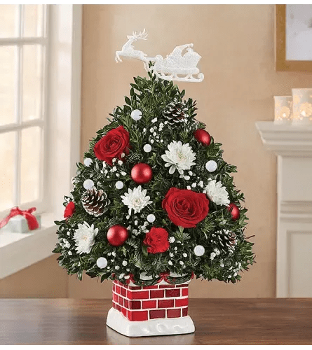 Christmas tree-shaped floral arrangement with red roses and white flowers