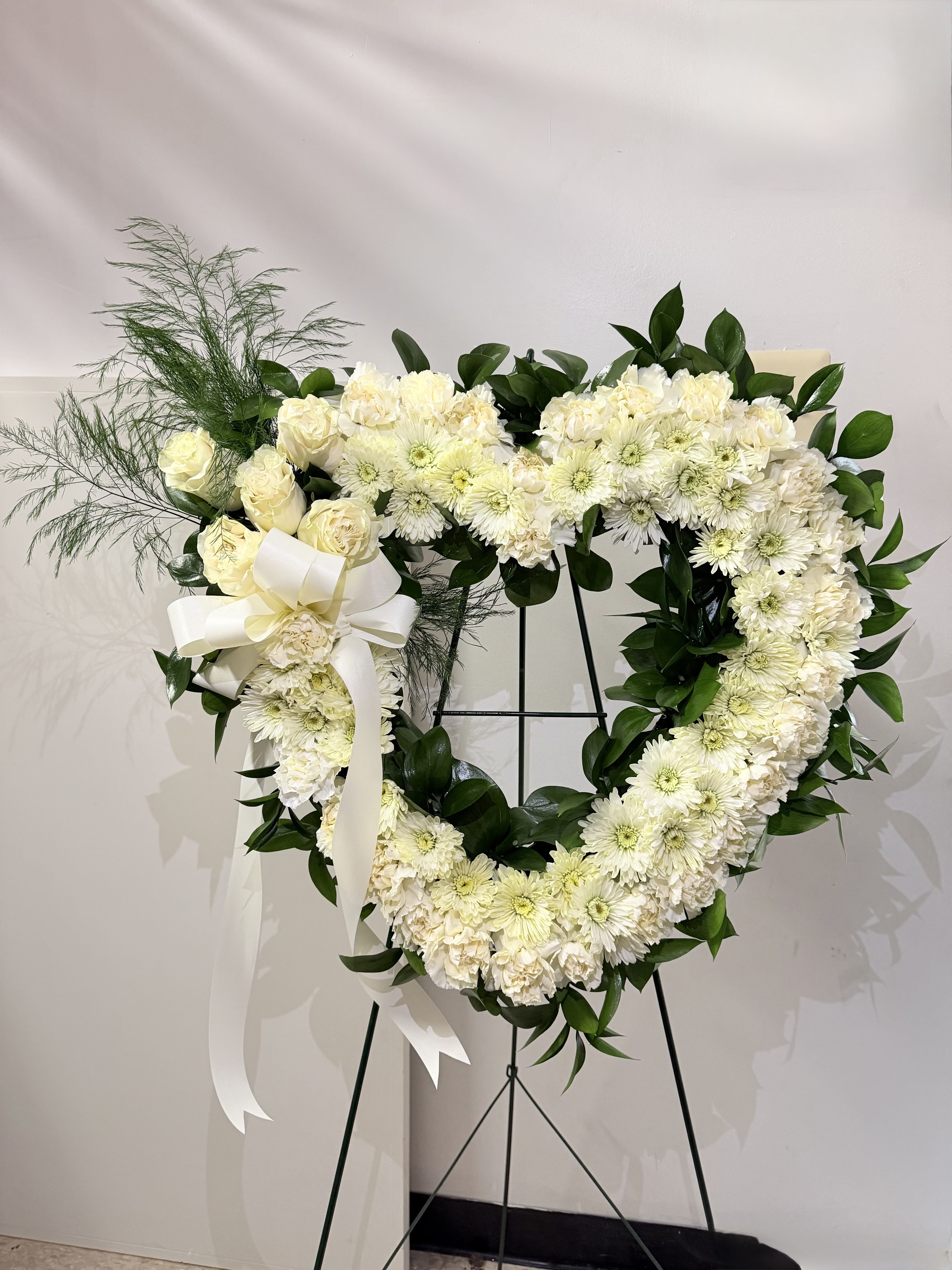 Our hearts speak to you wreath - Cream, white and green heart shaped wreath. If you would like this arrangement in another color please feel free to give us a call.